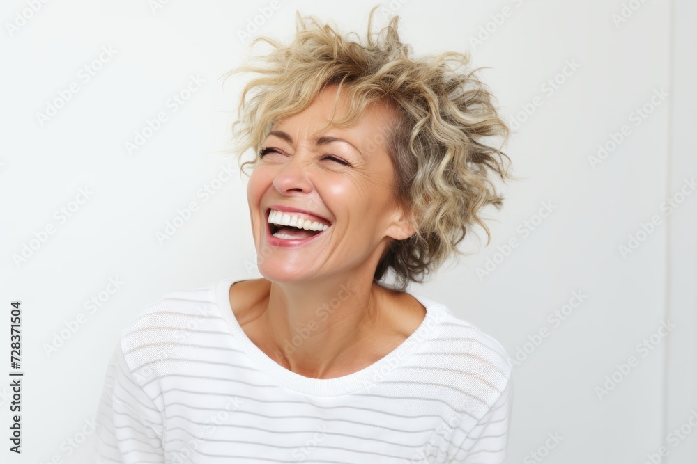 Happy middle-aged woman laughing and looking up on white background Happy middle-aged woman laughing and looking up on white background