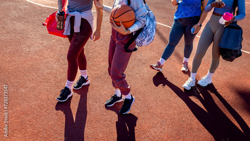 Close up of female legs walking on basketball court.