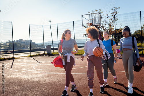 Diverse group of young woman walking on basketball court preparing to play. © Zoran Zeremski
