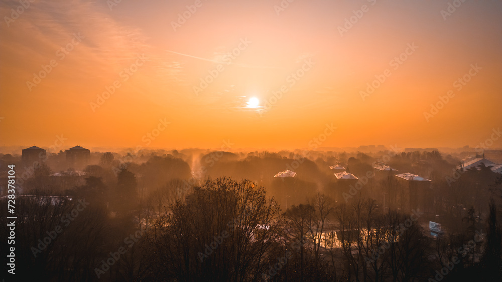 Foggy sunrise with San Donato Milanese skyline from a drone, Lombardia, Milano, Italia 4.02.2024