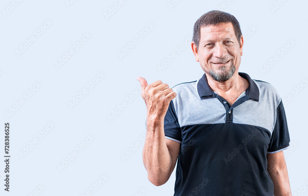 Smiling senior man pointing at a banner to the side. Senior old man pointing at promotion isolated Smiling senior man pointing at a banner to the side. Senior old man pointing at promotion isolated