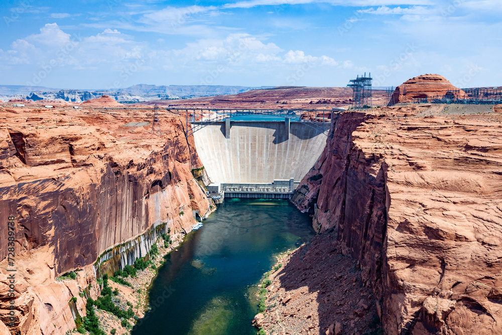 Glen Canyon Dam at river colorado is delivering electricity by water turbine to the whole area Glen Canyon Dam at river colorado is delivering electricity by water turbine to the whole area