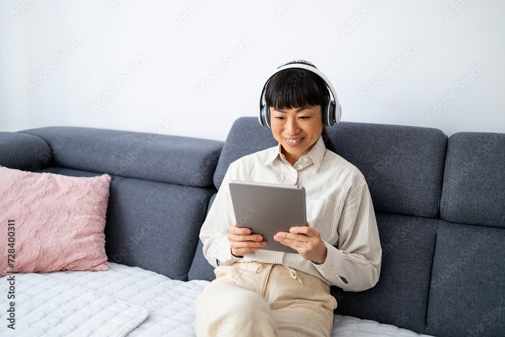 Japanese woman having online english classes at home. Japanese woman having online english classes at home.