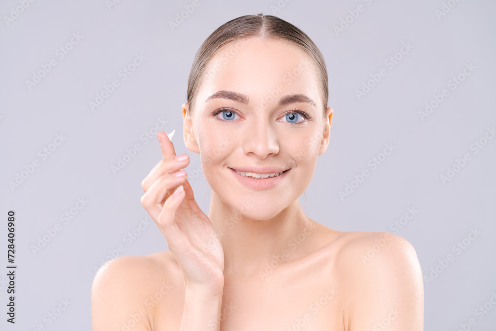 skincare and cosmetics concept with copy space for text. Woman with beautiful face with cream on her finger smiling skincare and cosmetics concept with copy space for text. Woman with beautiful face with cream on her finger smiling