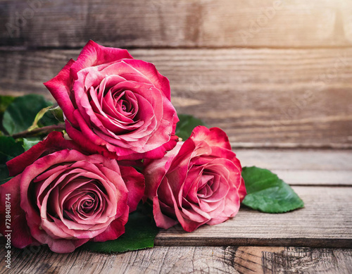 red and pink roses on wooden background