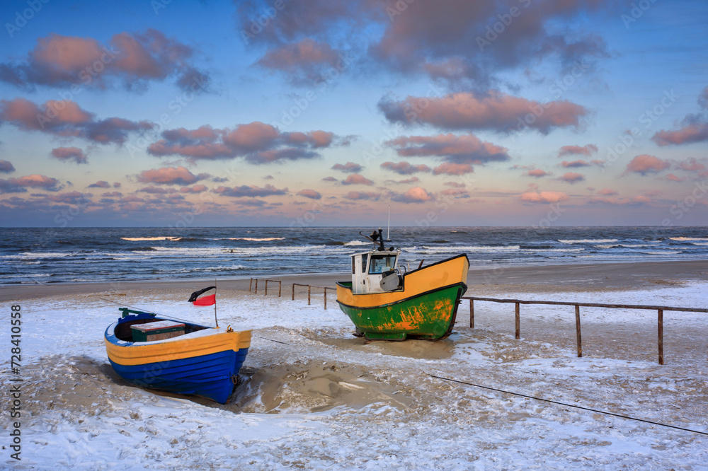 Fototapeta premium Fishing boats on the Baltic Sea beach in Jantar at winter. Poland