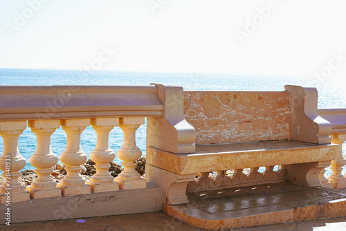 Stone bench to Sant Bartomeu i Santa Tecla church of Sitges in Spain photo