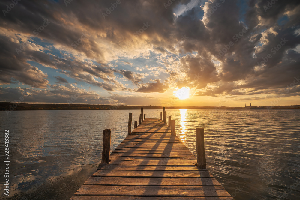 Obraz premium Small Dock at the lake water at sunset landscape, seascape sunrise