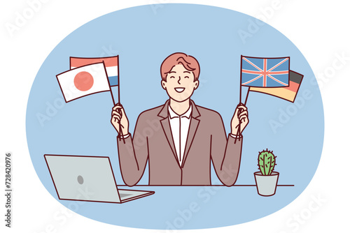 Satisfied man sits at table with laptop and shows flags different countries in solidarity with peoples of world. Positive guy who owns international business or diplomat politician. Flat vector image