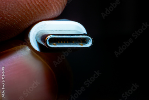 Innovative tech in hand - a close-up macro photo of holding a sleek C-type USB connector, capturing the essence of modern connectivity. photo