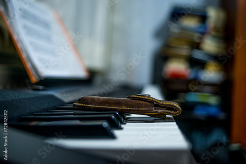 A creative juxtaposition: a sharp pocketknife placed on a piano, blending the utility of a tool with the harmony of musical keys photo