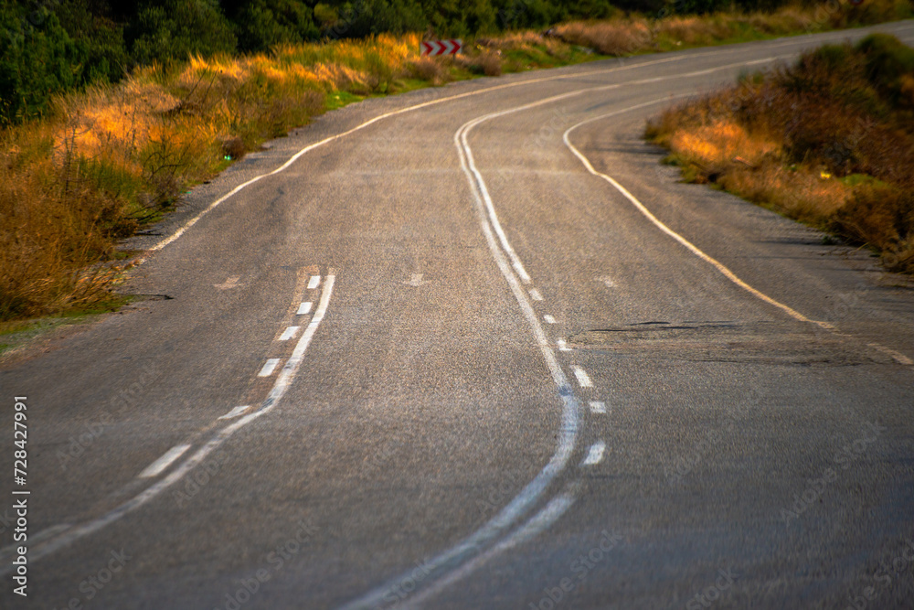 Detailed asphalt road profile: A closeup view showcasing the texture and surface intricacies of the road, inviting exploration of its unique characteristics Detailed asphalt road profile: A closeup view showcasing the texture and surface intricacies of the road, inviting exploration of its unique characteristics
