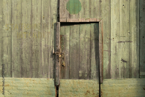Background old green wooden barn door and façade