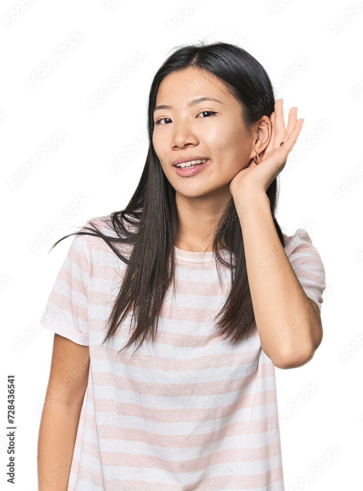 Young Chinese woman in studio setting trying to listening a gossip. Young Chinese woman in studio setting trying to listening a gossip.
