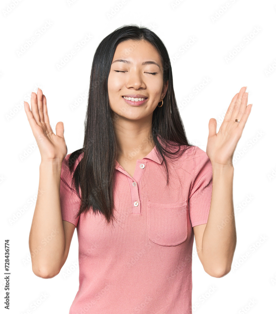 Young Chinese woman in studio setting joyful laughing a lot. Happiness concept. Young Chinese woman in studio setting joyful laughing a lot. Happiness concept.