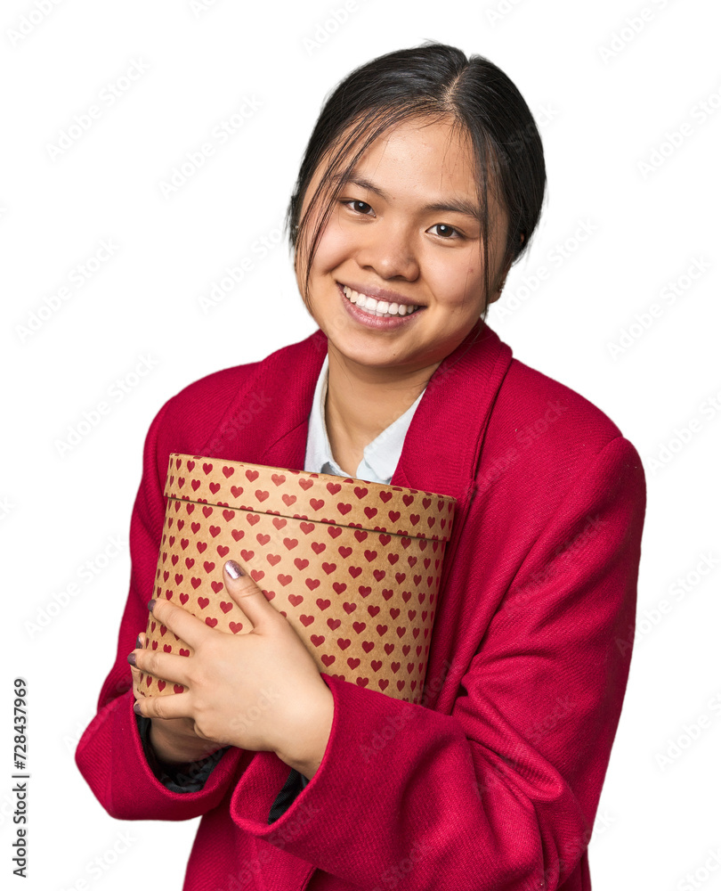 Young Chinese woman holding a heart-filled box laughing and having fun. Young Chinese woman holding a heart-filled box laughing and having fun.