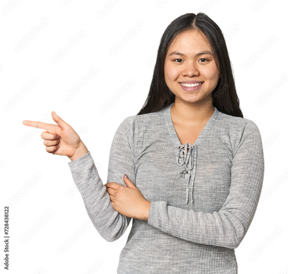 Young chinese woman isolated smiling cheerfully pointing with forefinger away. Young chinese woman isolated smiling cheerfully pointing with forefinger away.
