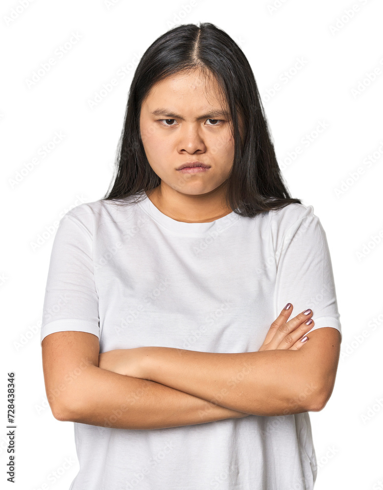 Young chinese woman isolated frowning face in displeasure, keeps arms folded. Young chinese woman isolated frowning face in displeasure, keeps arms folded.