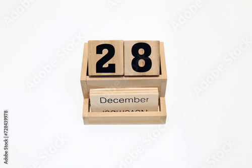 28th of December wooden perpetual calendar. Shot close up isolated on a white background 