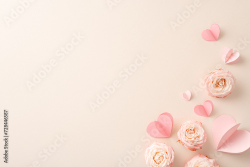 Shower your tender girlfriend with love on Women's Day! A captivating top view photo featuring delicate rose buds and sweet hearts on a pastel beige background. Ample space for your special text or ad