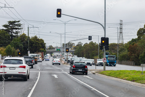 Stopping at orange lights at intersection in city