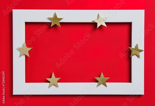 Gold stars decorating a white frame on a bright red background for a holiday theme