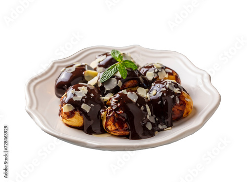 Obraz na płótnie Delicious profiteroles with chocolate and white plate. Selective focus image on light background. w salonie
