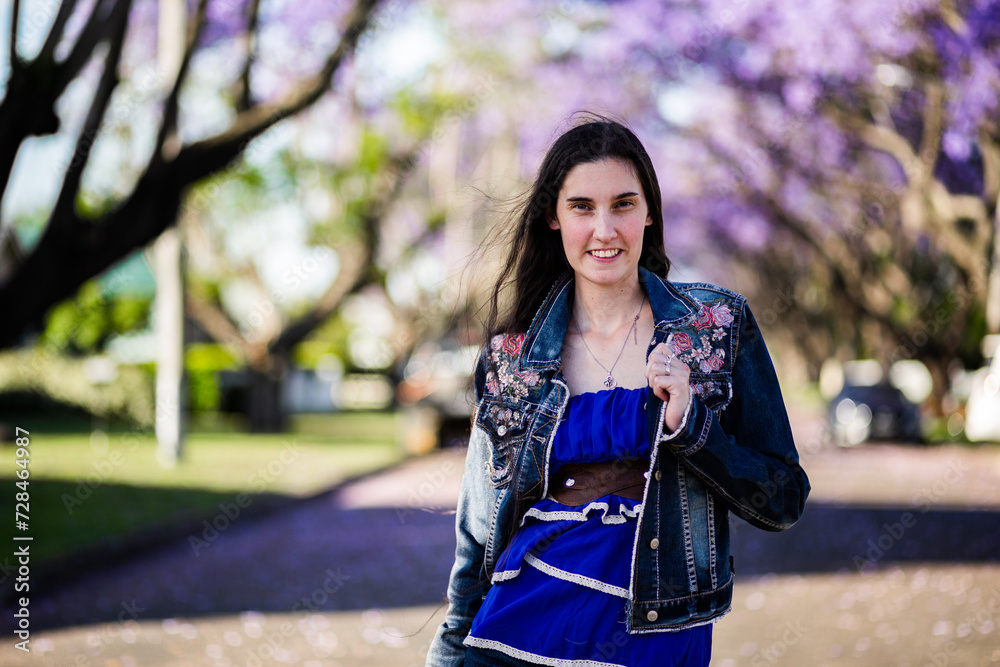 Person walking outside in spring smiling at the camera Person walking outside in spring smiling at the camera