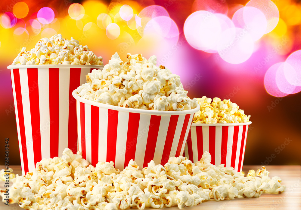 Popcorn in red and white striped paper buckets at the cinema. Popcorn stand Popcorn in red and white striped paper buckets at the cinema. Popcorn stand