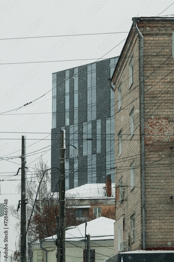 Chernihiv, Ukraine - February 3, 2024. The modern and historical architecture of the city is covered in snow. it snowed on the weekend, but people are walking. gray and cloudy sky. Chernihiv, Ukraine - February 3, 2024. The modern and historical architecture of the city is covered in snow. it snowed on the weekend, but people are walking. gray and cloudy sky.