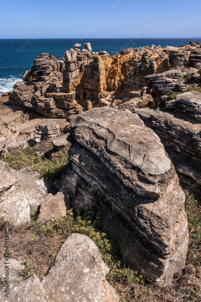 Rock formations in the site of geological interest of the cliffs of the Peniche peninsula, portugal, in a sunny day.