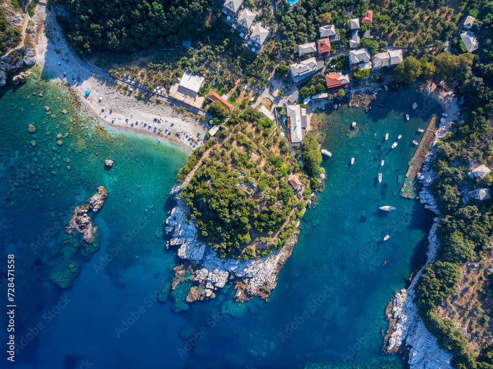 Aerial top down view of the idyllic fishing village of Damouhari with connected beach, North Pelion, Greece