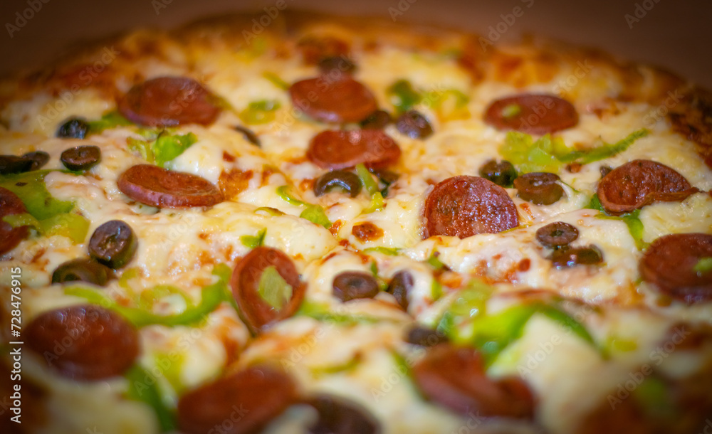 Close up shots of a delicious pepperoni pizza with Mozzarella cheese, salami, pepper, and fresh olives  Italian pizza