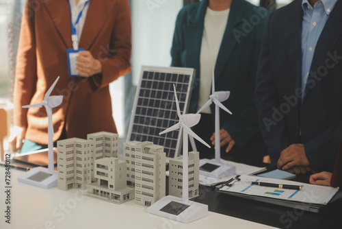 Close-up at tablet, Engineers pointing at tablet with their hands. To jointly design the use of renewable energy with wind and solar energy. Concept of using renewable energy.