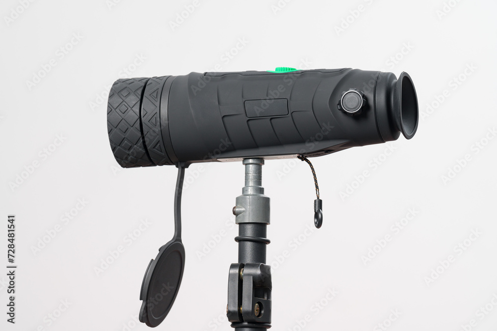 Monocular on a tripod isolated on a white field.