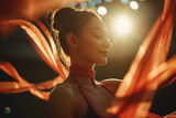 beautiful young woman in red silk ribbons on stage with lights