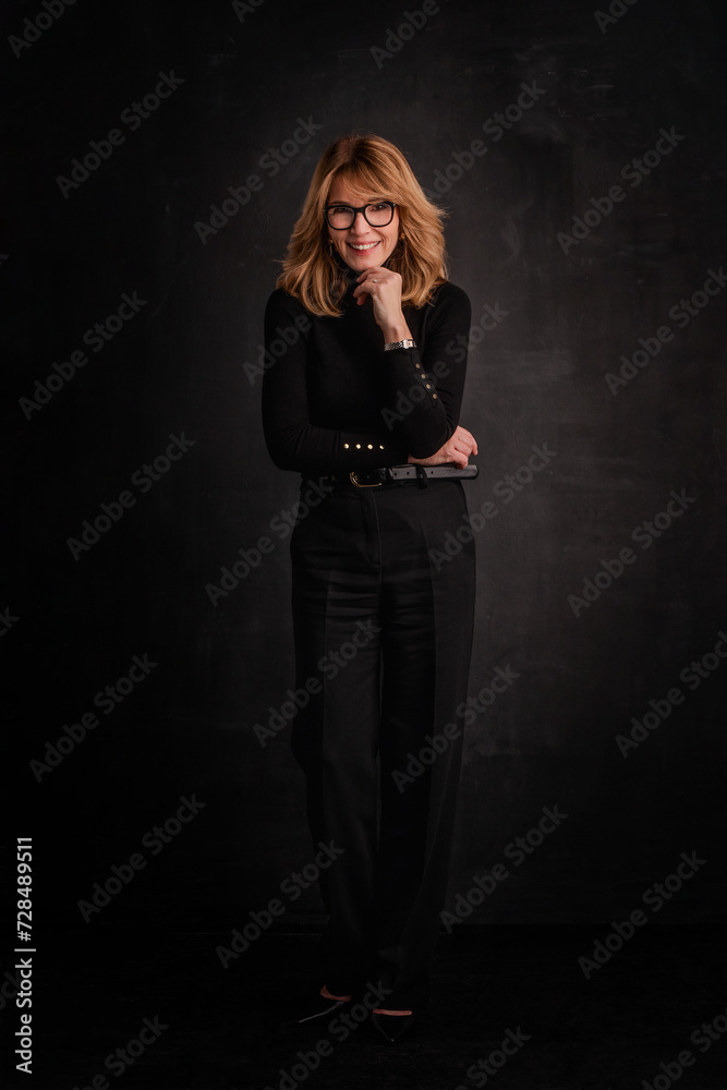 Full length studio portrait of an attractive mid aged woman against isolated background Full length studio portrait of an attractive mid aged woman against isolated background