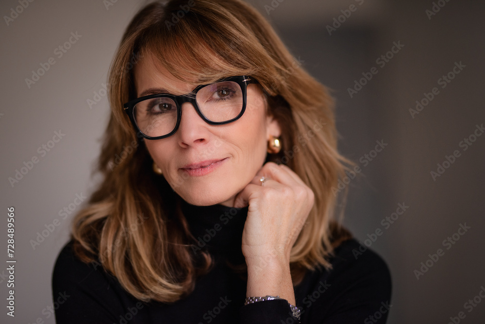 Close-up portrait of an attractive mid aged woman smiling to the camera