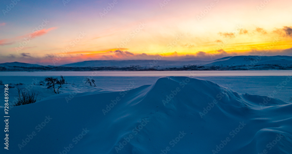 Pink sky and blue snow. Winter sunset in Finland