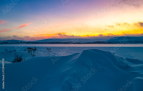 Pink sky and blue snow. Winter sunset in Finland