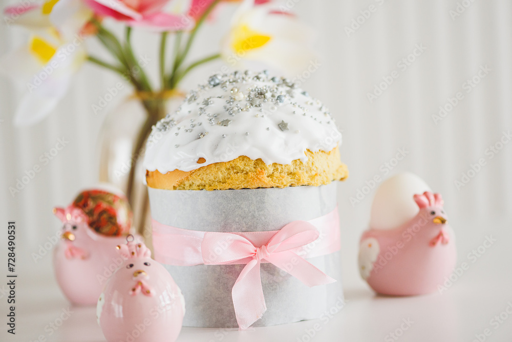 Traditional Easter cakes or sweet bread with hen figurines and eggs on white table. Front view Traditional Easter cakes or sweet bread with hen figurines and eggs on white table. Front view