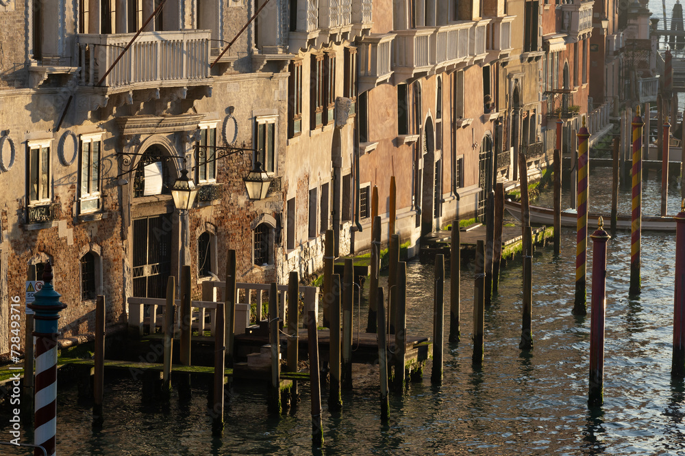 Morning Gold light over Old Small Piers for Gondolas in Venice - Scenic detail of the Lagoon City