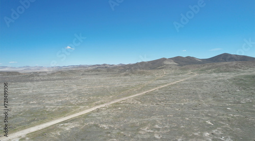 Scenic desert with hills against the background of a blue sky. Nevada, USA © Wirestock