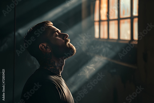 a man sitting in a jail cell with light beaming out