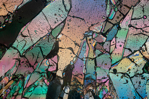 Polarized light microscopy creates a stained-glass effect in this detailed image of erythritol sugar crystals with vibrant colors