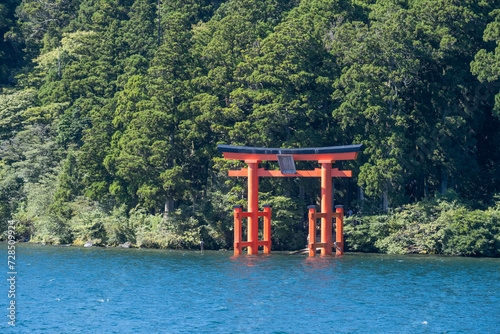 A“red gate of peace” (heiwa no torii) in Hakone-jinja shrine standing proud and tall in Ashinoko Lake, Kanagawa prefecture, Japan  photo