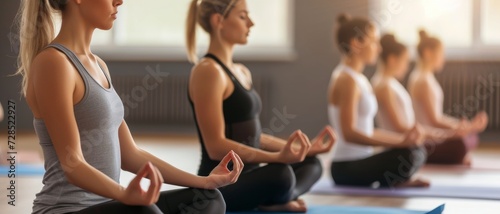 Group of women in a peaceful yoga session in a studio, practicing mindfulness and harmony