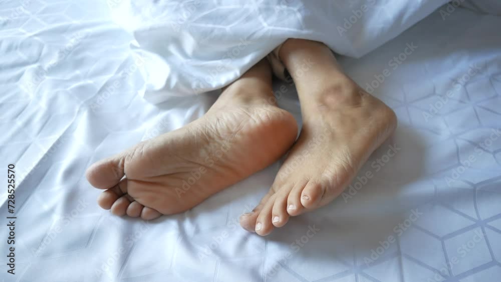 young Woman lying with bare feet in bed, young Woman lying with bare feet in bed,
