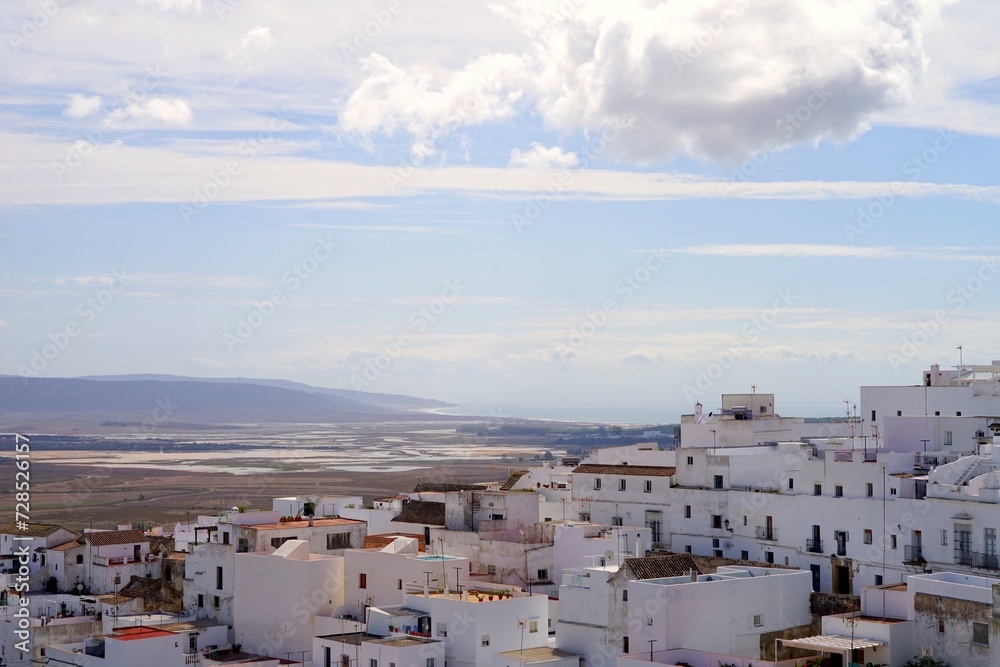 view over the roofs of the white Andalusian houses in Vejer de la Frontera towards the Cultivos piscicolas de Barbate and the Atlantic Ocean at the horizon, Andalusia, Costa de la Luz, Spain