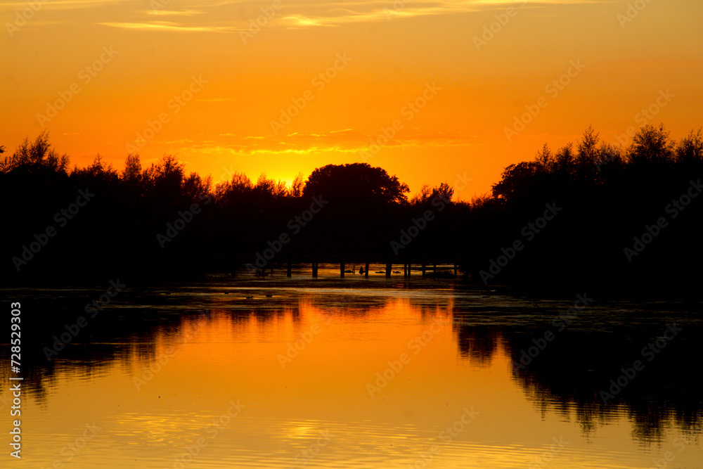 Fototapeta premium Colorful sunset by the lake.